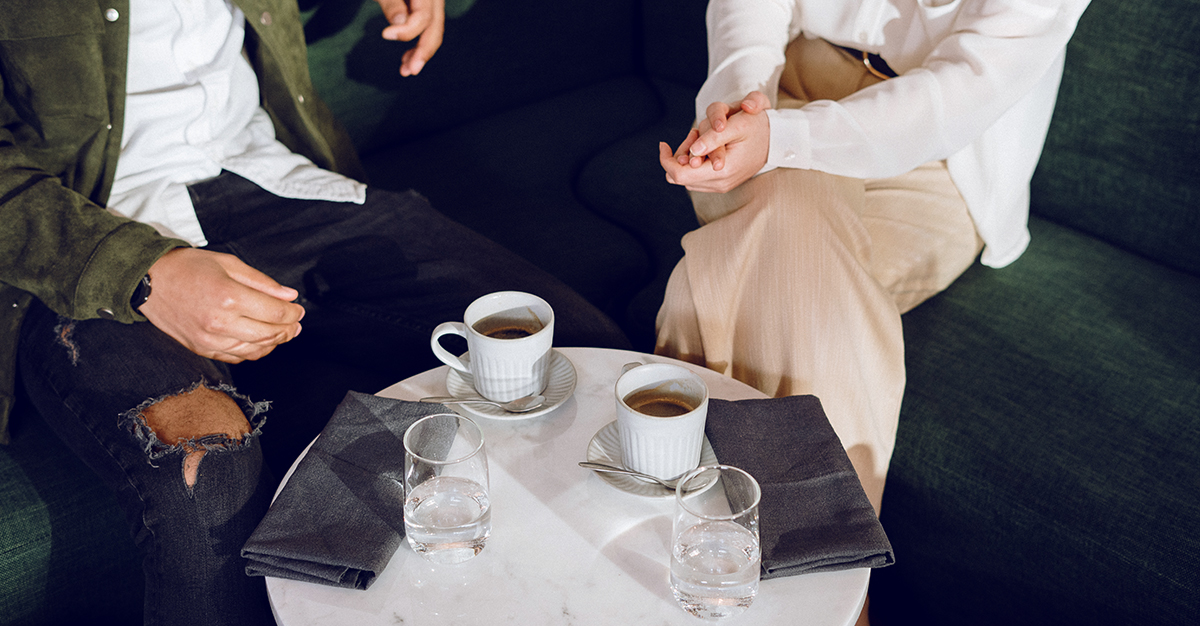 A couple chats over coffee.