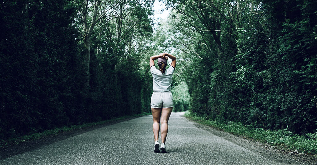 Woman going for walk alone in the woods. 