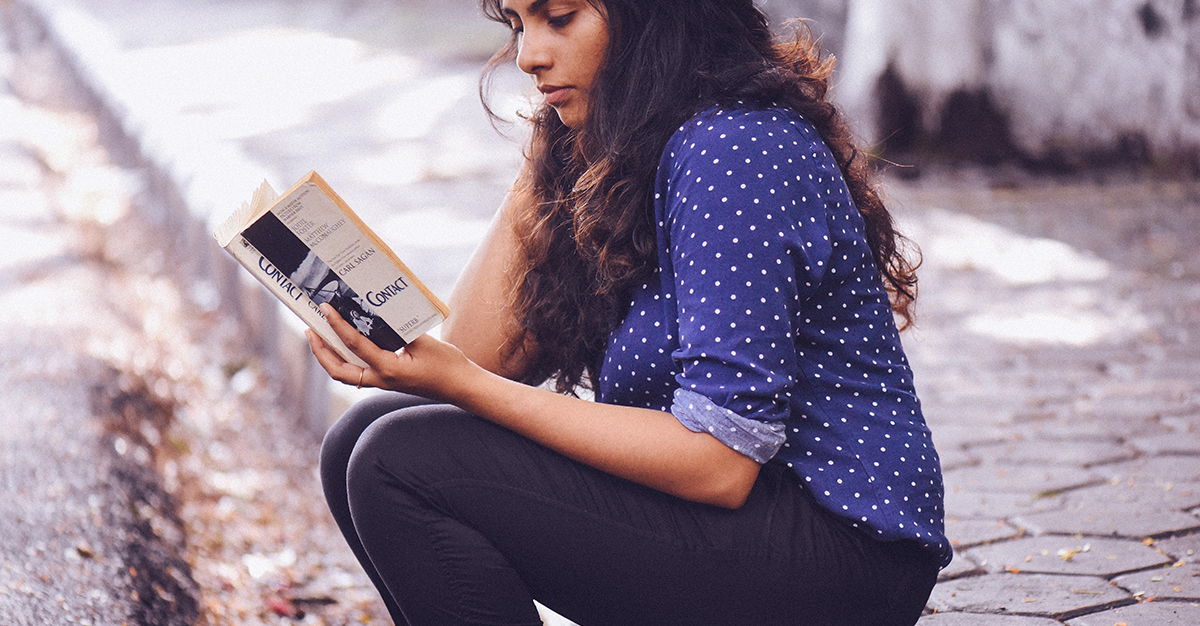 Woman reading a book outside